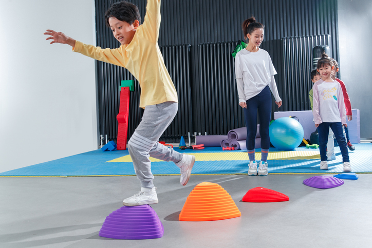 class-obstacle-course Kids doing an obstacle course in the school gym
