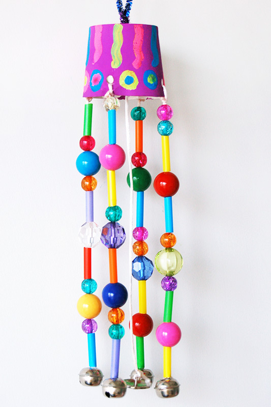 beadedwindchimes A paper plate is painted pink and has strings with beads on them hanging down from it (second grade art)