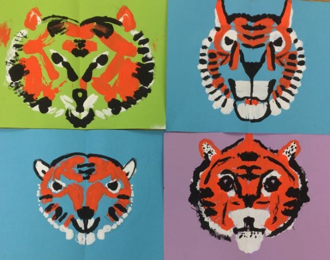 Second Grade Art: Symmetrical Tigers Symmetrical tiger faces printed with paint on colored backgrounds (Second Grade Art)