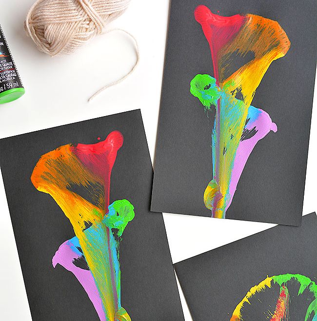 Second Grade Art: String Painting Painted designs made by pulling paint-covered string along black paper