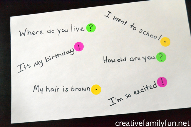 punctuation-stickers-cover-Creative-Family-Fun A white piece of paper with sentences written and colorful punctuation stickers at the end