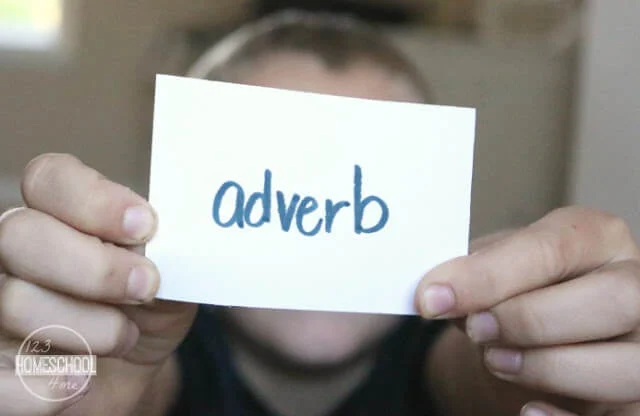 parts-of-speech-grammar-game-review A boy holds up a card with the word