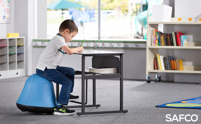 student sitting on swivel ball chair as example of flexible seating