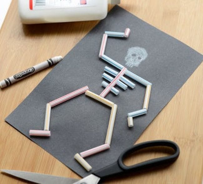 Halloween Games Education A skeleton on a black piece of paper made from segments of drinking straws