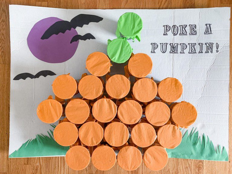 poke-a-pumpkin A poster board titled Poke a Pumpkin with a collection of cups covered with orange paper to look like a pumpkin