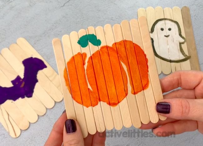craft-stick-halloween-puzzle A puzzle made from craft sticks with a pumpkin painted on it