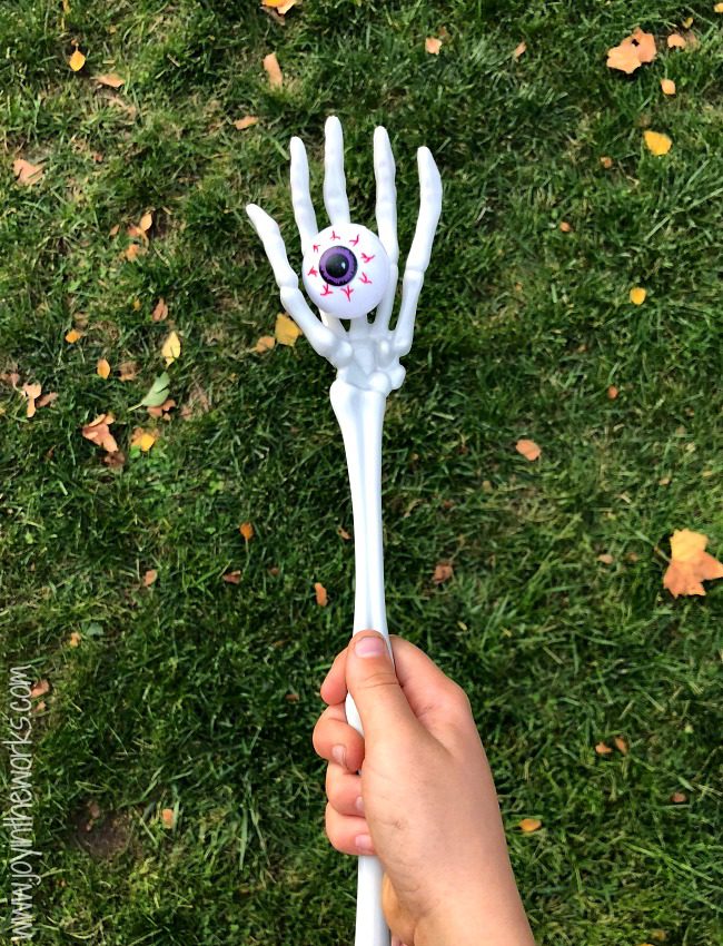 eyeball-race A child's hand is shown carrying a skeleton arm that has a fake eyeball in the hand portion (Halloween Activities)