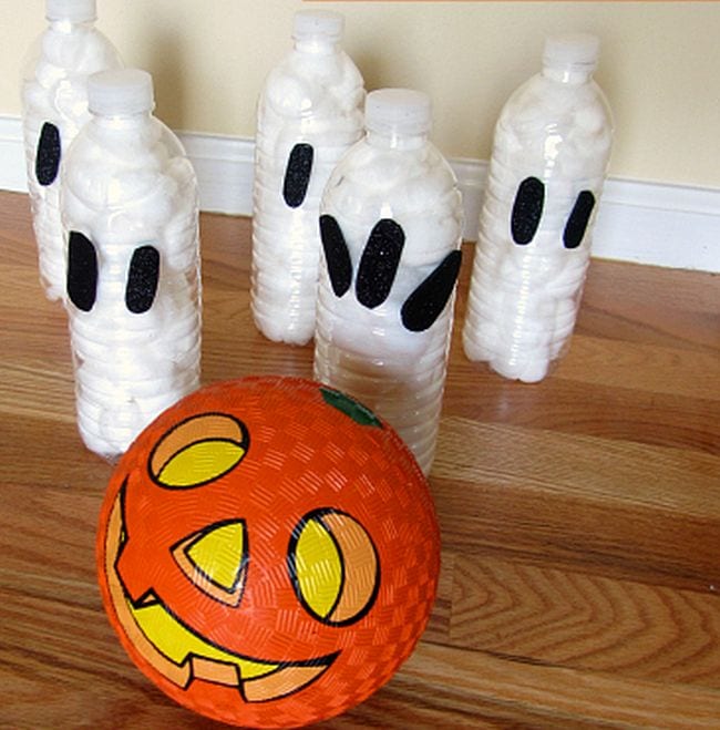 bowling-for-ghosts An orange pumpkin ball hits bowling pins made from plastic bottle