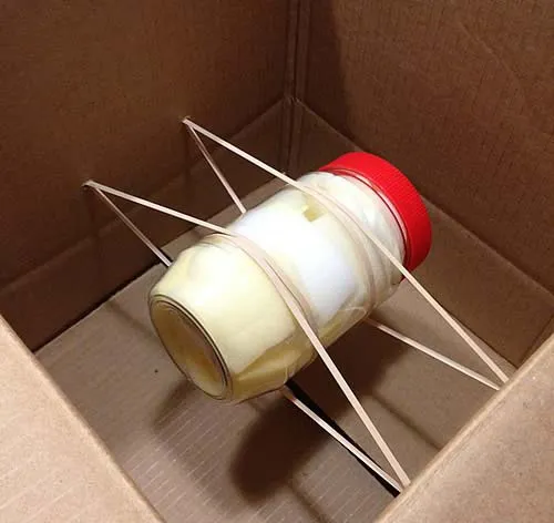 peanut-butter-egg-drop peanut butter jar tied to a box with rubber bands