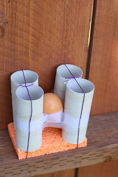 toilet-paper-roll-egg-drop egg held in place on a sponge with toilet paper rolls and rubber bands and tape