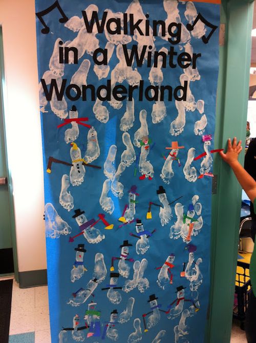 Winter Classroom Doors: Walking in a Winter Wonderland Classroom door decorated with white paint footprints reading Walking in a Winter Wonderland