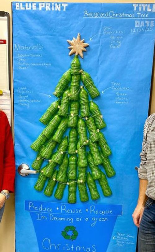 Winter Classroom Doors: Green Christmas Door decorated with a Christmas tree made of empty plastic bottles painted green