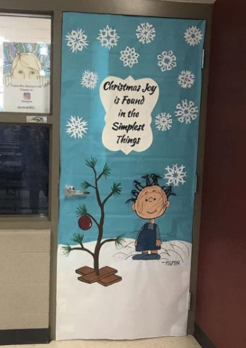 Winter Classroom Doors: Charlie Brown A classroom door is decorated with the characters from Charlie Brown and the famous shabby Christmas tree from the movie.