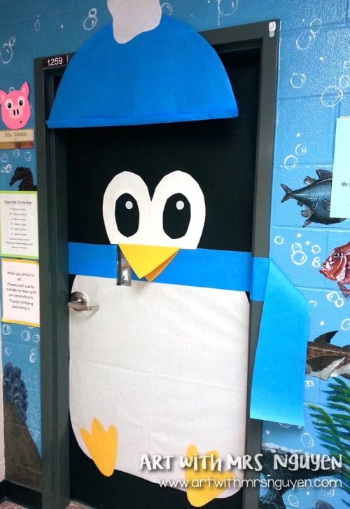Winter Classroom Doors: Large Penguin A classroom door is decorated to look like a large penguin wearing a blue hat and scarf.