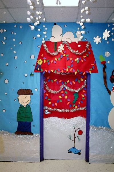 Winter Classroom Doors: Snoopy Dog House A classroom door has Snoopy's dog house on it decorated for Christmas.