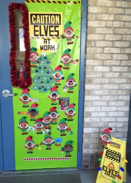 Winter Classroom Doors: Elves at Work A door says Caution Elves at Play and has elves with the students in the class's face on them.