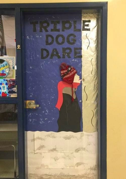Winter Classroom Doors: A Christmas Story Classroom door decorated with a boy with his tongue stuck to a flagpole, with text reading Triple Dog Dare- holiday classroom doors