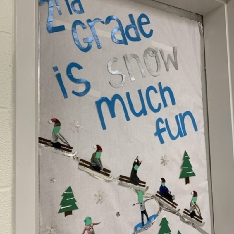 Winter Classroom Doors: Sledders A classroom door is decorated with sledders going down a snow covered hill. Text reads 2nd grade is snow much fun.