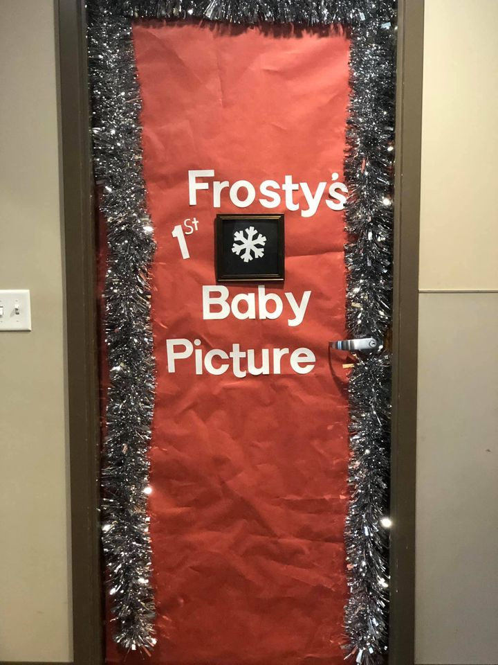 Winter Classroom Doors: Frosty’s Baby Picture Holiday classroom doors include this one that is all red and has a tiny snowflake on it. Text reads Frosty's Baby Picture.