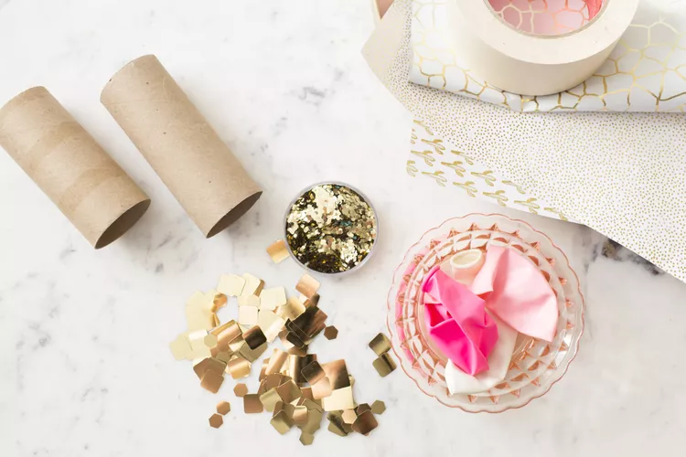 confetti-poppers Materials required to make DIY confetti poppers- toilet paper roll, confetti, balloons, tape and paper
