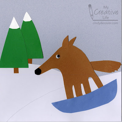 sledding-dog A winter scene made from construction paper featuring a handprint-traced dog