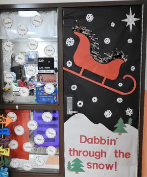 Winter Classroom Doors: Dabbin Through the Snow A sled has photos of kids in the class doing the dab dance and text reads Dabbin Through the Snow