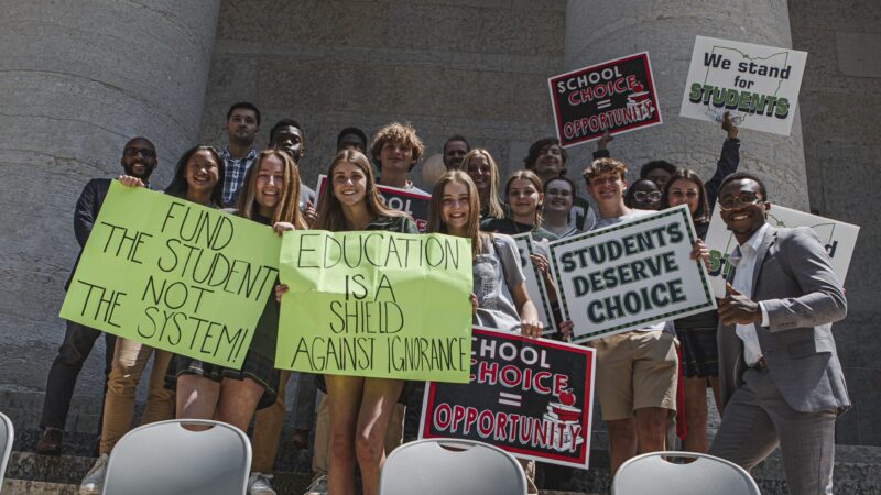 school-choice-ohio people advocating for school choice reform with signs
