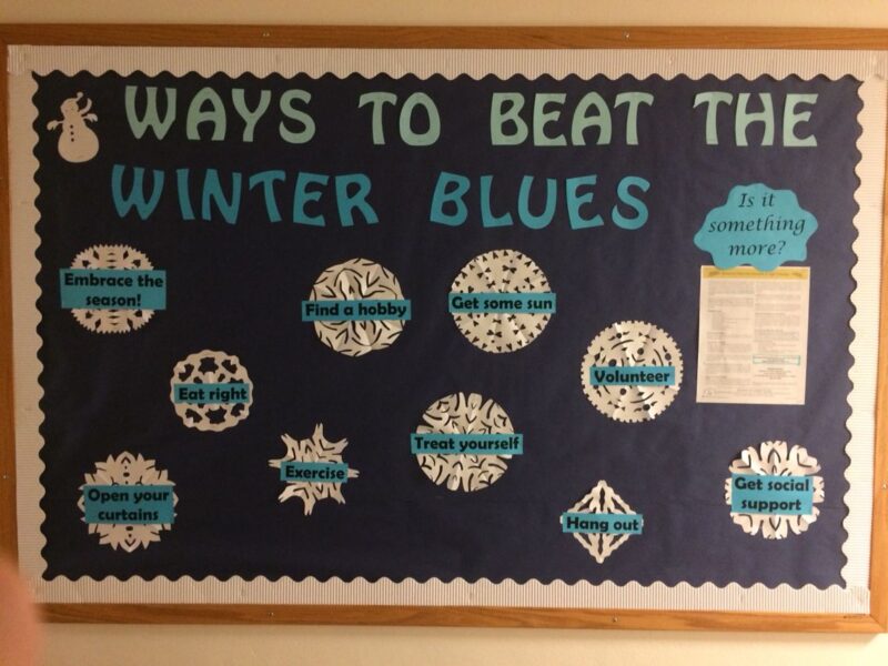 New Year Bulletin Beat Winter Blues A black background says Ways to Beat the Winter Blues. There are also snowflakes that have suggestions like eat right and exercise.