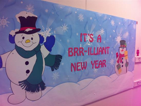 New Year Bulletin Snowmen A bulletin board has two snowmen on it and says It's a brrrr-illiant new year.