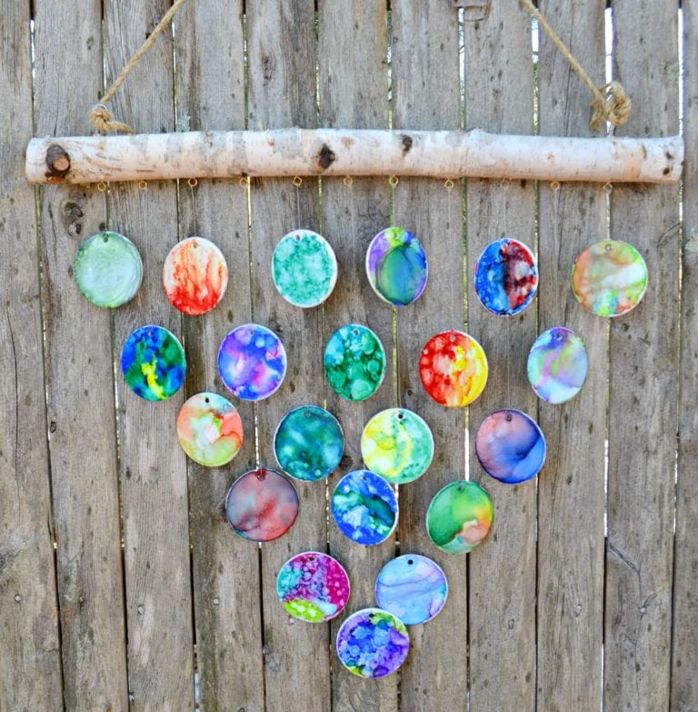 Ceramic Wind chimes Hand-painted ceramic wind chimes hanging in a triangular shape on a wooden fence as an example of school auction projects.