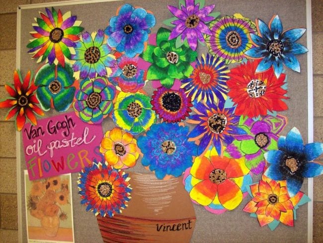 collaborative-art-flower-vase A collaborative art project featuring a painted pot filled with colorful blooms, each one made by a different student