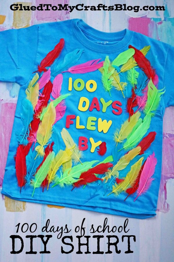 100th Day Shirt: Feathers 100th day of school shirt ideas include this teal shirt that has brightly colored feathers glued to it and stickers that read 100 Days Flew By (100th day of school shirt ideas)