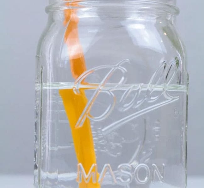 First Grade Science Experiments Mason jar of water with a pencil in it, viewed from the side