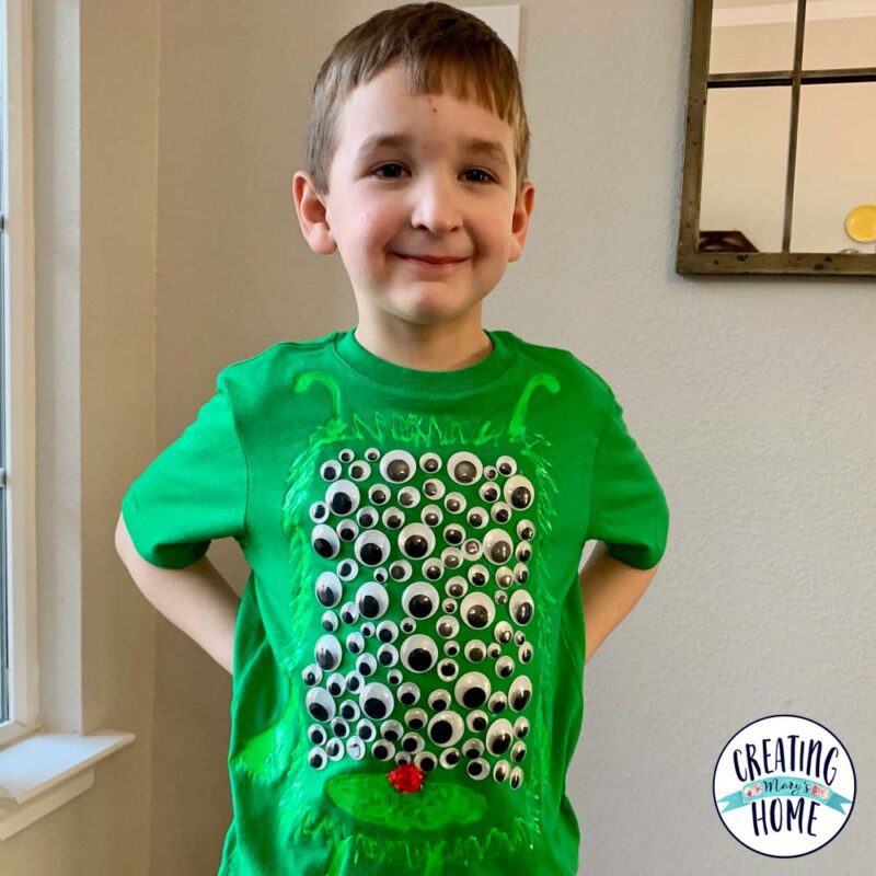 100th Day Shirt: Green Googly Eyes A little boy wears a green shirt that has googly eyes on it.