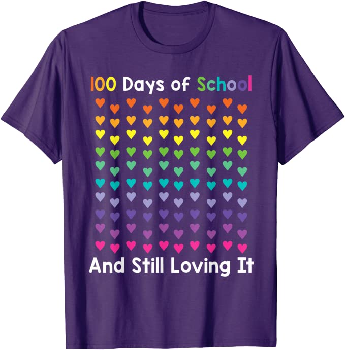 100th Day Shirt: Hearts A purple shirt says 100 Days of School And Still Loving It. There are 100 hearts on it in all different colors.