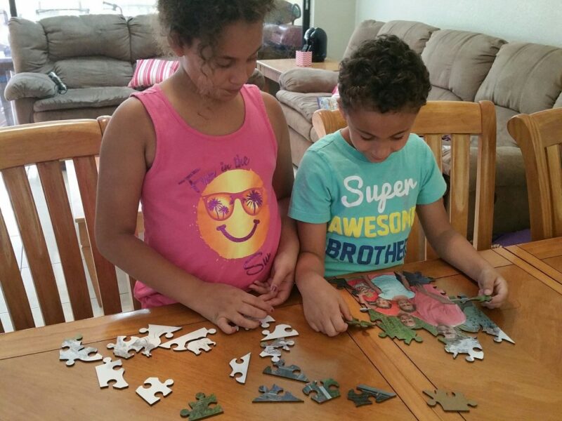 kids-putting-together-a-puzzle kids putting together a puzzle for a fun friday activity