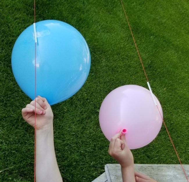 Kindergarten Science Activities: Balloon Rockets Students holding the ends of balloons taped to drinking straws on a string