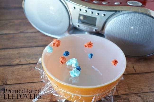 Kindergarten Science Activities Sound Waves Yellow bowl covered tightly with plastic wrap, with popcorn on top, next to a boom box
