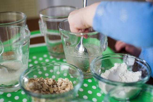 Preschool Science: Dissolves in Water Preschool science student mixing various solids into glasses of water
