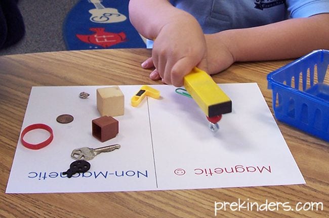 Preschool Science: Magnets Preschool science student using a bar magnet to test other objects