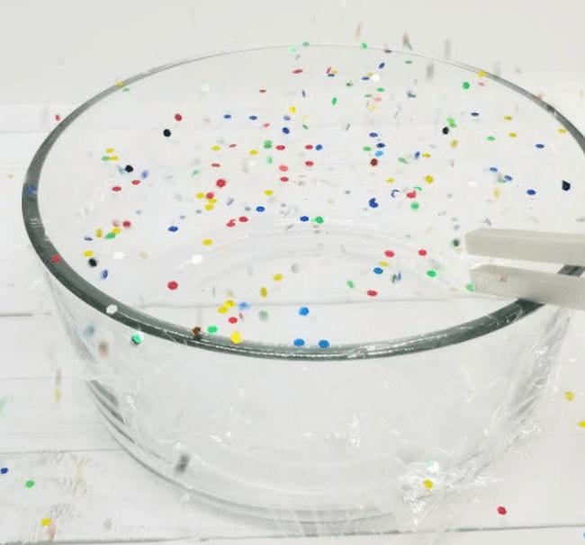 Preschool Science: Sound Waves Glass bowl covered in plastic wrap with confetti on top, and a tuning fork touching the plastic
