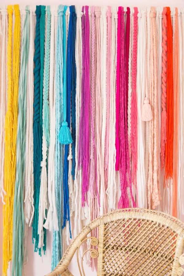 wall-hanging A colorful wall hanging made from individual strands of hand dyed yarn