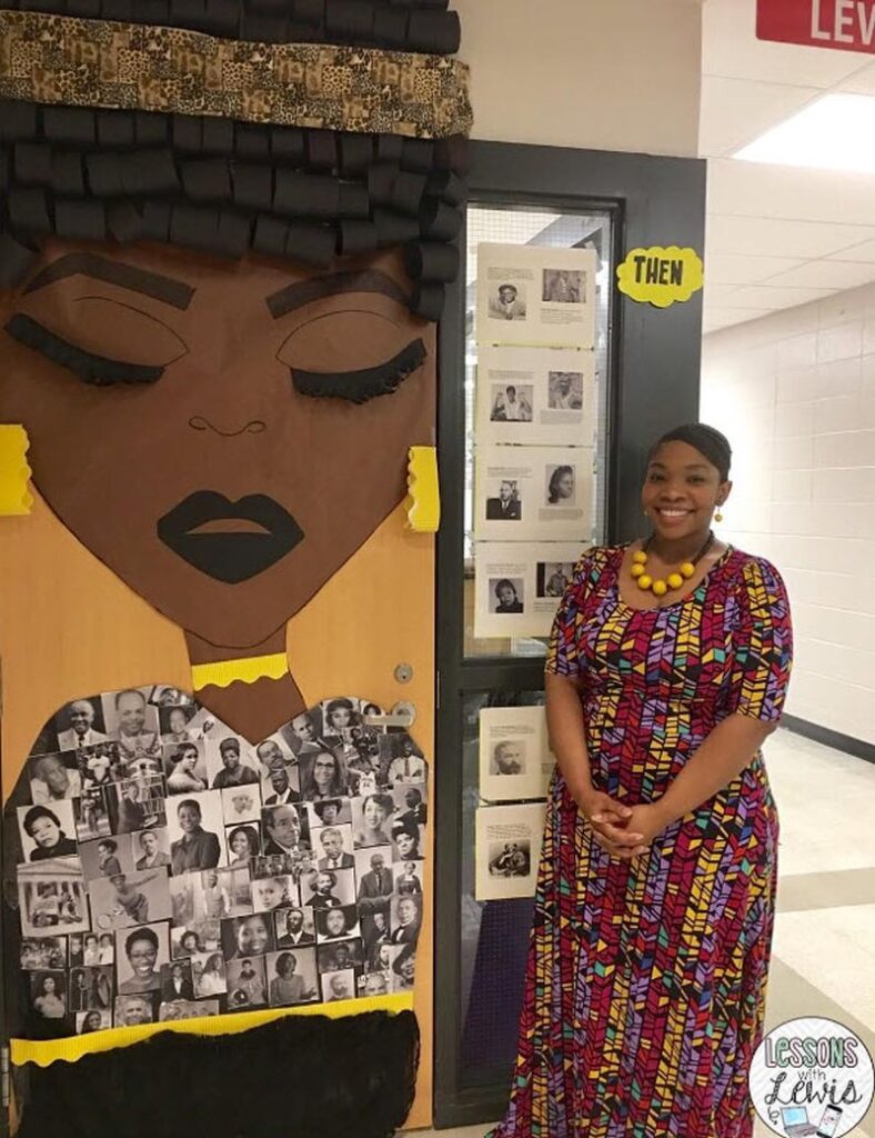 Black History Month Door Black teacher standing by her classroom door decorated with a Black woman's head made of construction paper