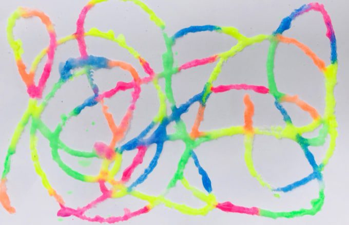 Third Grade Art Projects: Salt Painting Brightly colored puffy paint is swirled across a paper.