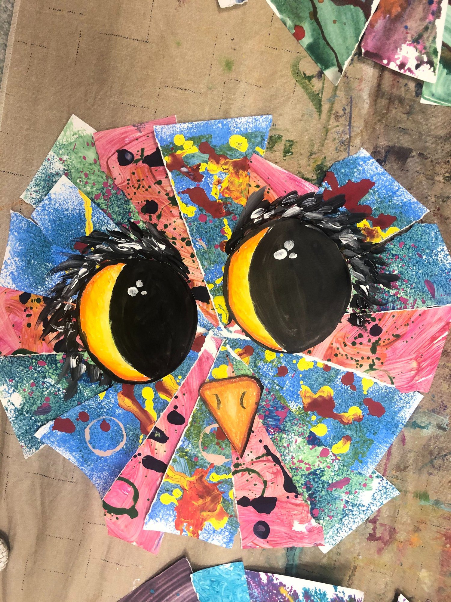 Third Grade Art Projects: Mixed Media Owls An owl is created from triangluar shaped papers that have paint splattered on them. Two large owl eyes are drawn on and a beak.