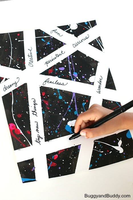 Third Grade Art Projects: Goal Setting Art white strips separate black shapes with bright paint splatterd on them. A hand is seen writing words on the white areas.