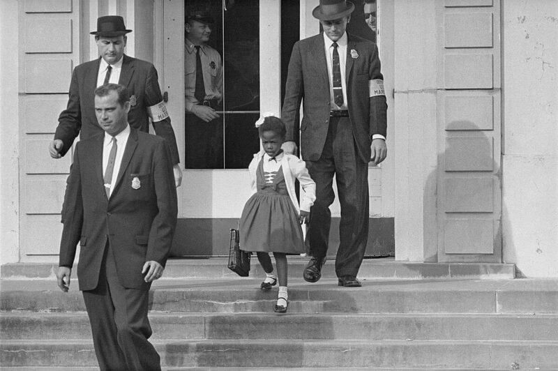 Ruby Bridges and Federal Marshals Young Ruby Bridges being escorted into an all-white school by U.S. Federal Marshals