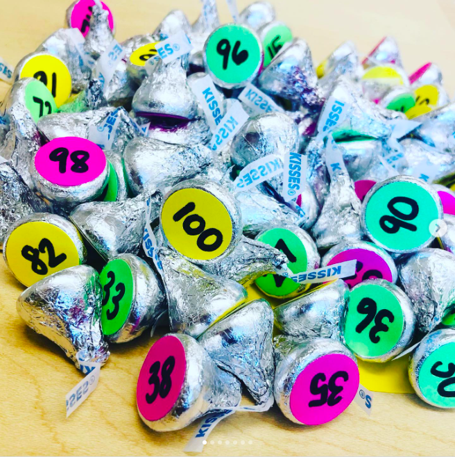 kisses A pile of Hershey's kisses, each with a colorful number sticker on the bottom