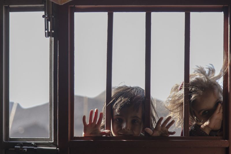 Picture Prompts: Peek-a-Boo Two children peering in through a barred window