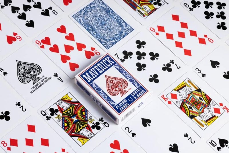 Playing Cards Playing cards laid out on a table with a box on top